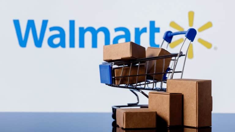 stock image showing a mini shopping cart in front of a walmart logo to illustrate the walmart affiliate program
