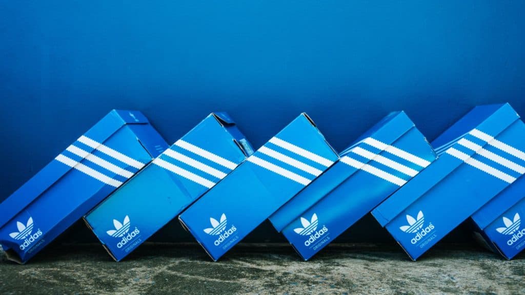 image showing a box of adidas shoes in boxes stacked next to one another - promoted by the adidas affiliate program